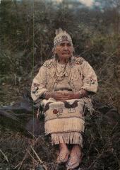 [Woman in regalia from the interior]